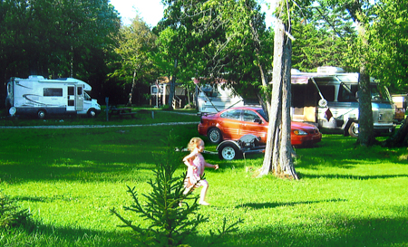 Our Curtis MI Lakeside Campground includes water, electric, bathhouse, dump station, picnic table, fire pit, and a sandy beach. 